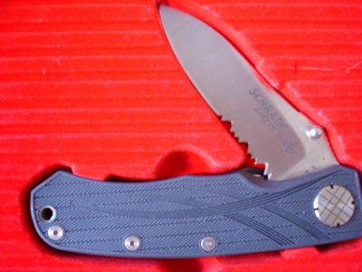 SLW2 with a USA tang stamp and a SERRATED BLADE.