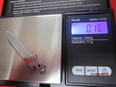 with most of the rough grinding done. all the stock was taken off the pile side of the blade so as not to damage the tang stamp. weighing in a .16 oz and dropping...