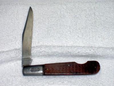 It is a model 063 with a reddish-brown  handle.