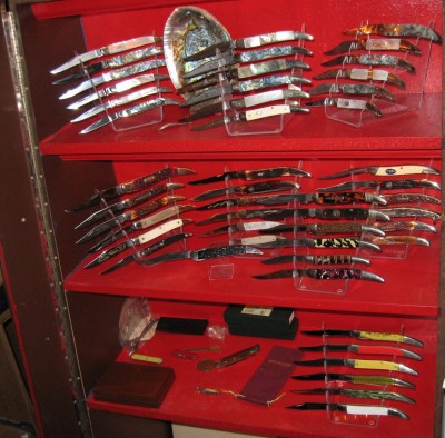 Taking up space in an old Schrade Walden display case.  WW2 Emergency Fishing knife is on second shelf, on single stand in the center.
