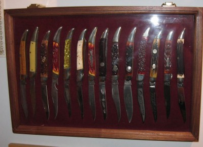 hanging on the wall two.  A toothpick without a clip blade shown here:  AG Russell with leaf shaped blade.  To it's left is another AG special, with an extreme clip blade.  Second from right is an AG Russell with a neat bolster lock.  AG seems to appreciate the tickler pattern.