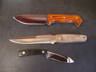 A Becker BK-2 in Cocobolo,<br />a Camillus CQB -Close Quarter Battle,<br />and a Schrade 518SC.