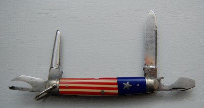 Remington UMC Circle #4233, Red, White &amp; Blue Celluloid Covers, 3 3/8” closed<br />Long pull spear blade is 90% full and a tad short, pinched and lined nickel silver bolsters<br />Inlaid star shield and a slightly tipped awl but overall a very fine example of a very rare knife!
