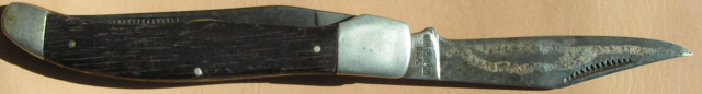 An old wood handled Marked Norm Thomson