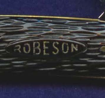 Robeson "shield" impressed into black composition post-war knife and filled with white paint.