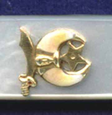 A Shriner's shield on a pearl handled pen knife.