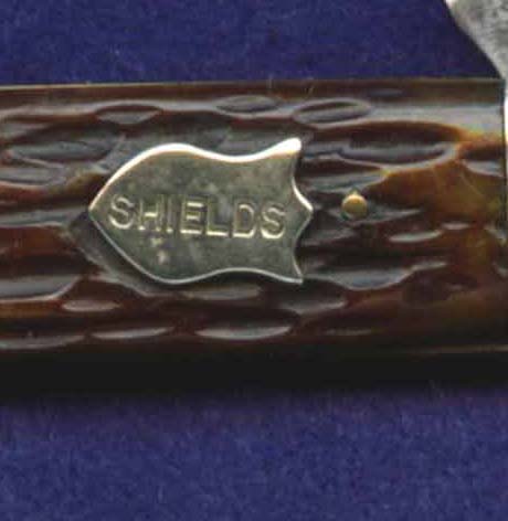 This shield is on a two blade utility pen knife. I have no idea who "Shields" might have been.