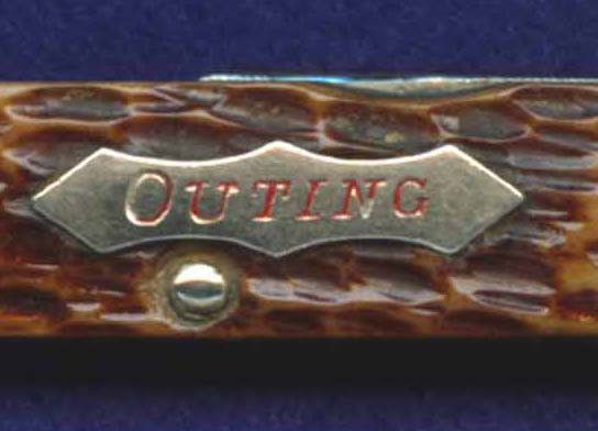 Outing shield on a small, junior sized four blade scout-utility knife.