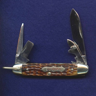 A junior sized four blade scout with &quot;OUTING&quot; shield.
