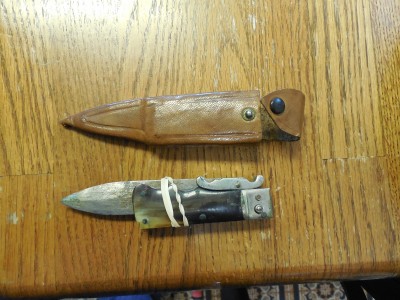 With sheath.  Need rubber band to keep closed.