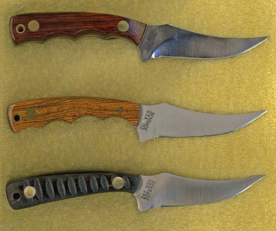 I have always like Sharpfingers and in 2008 I did a bunch of them. The top one has a cocobolo wood handle and finger grooves.<br />The middle one is presentation grade Bokote also with finger grooves.<br />The bottom Sharpfinger has a handle of the impala jigged water Buffalo horn.
