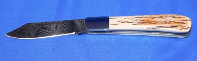Blade &amp; Spring: 1/8" Twist Damascus - Flat Grind, 400 series Liners &amp; Bolsters. 3 7/8" Closed length. Handle material: Stabilized Mammoth Ivory