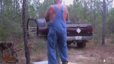 Some old man checking the deer feeder