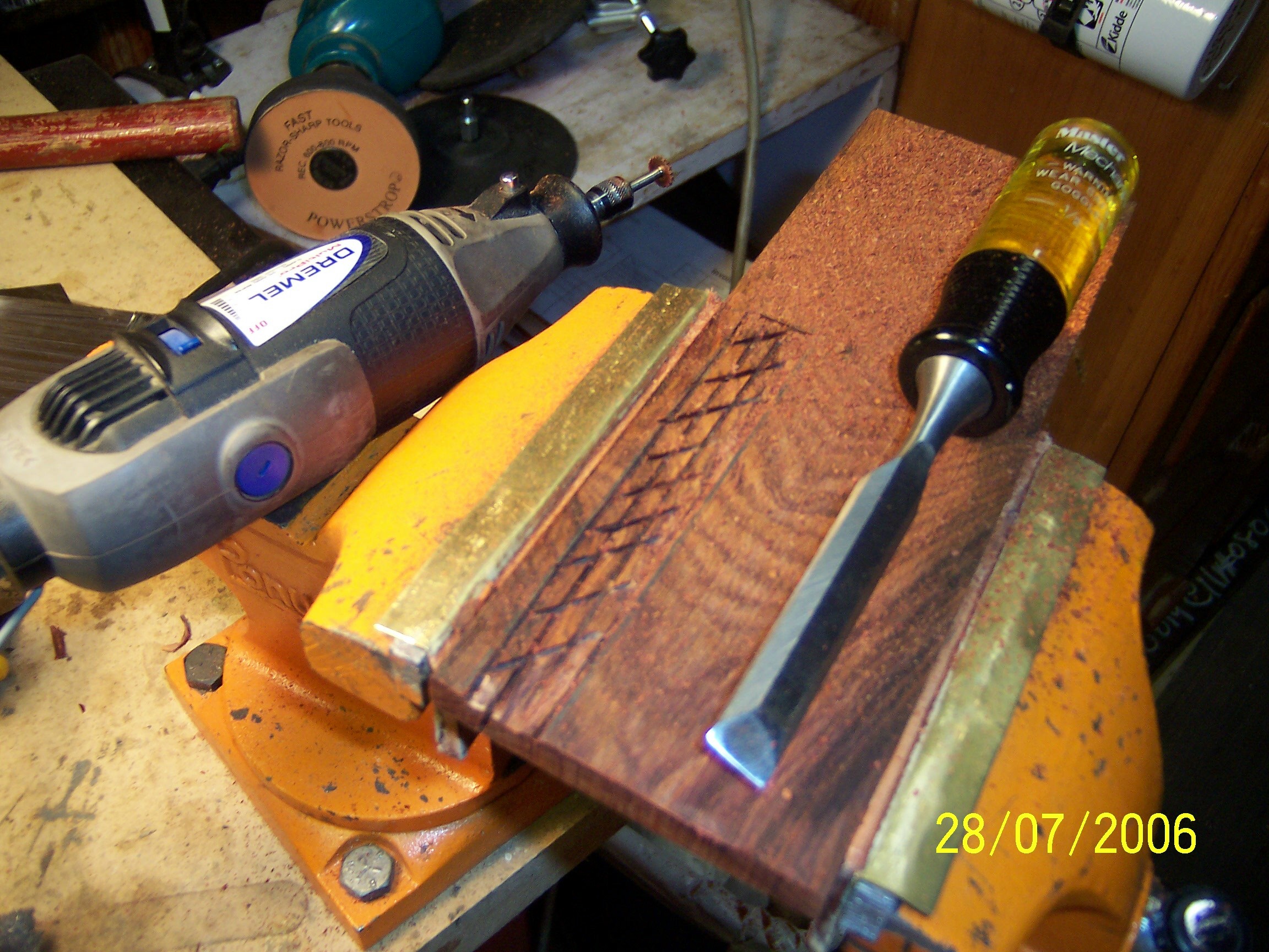 Here's one half of the handle in the vice, ready for me to cut the mortise for the tang.  Since this time I have a router attachment for my Dremel which would make this job much easier.