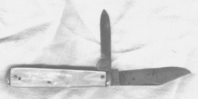 Careful review of this knife under a higher powered loop shows the Tang Stamp to be CORNWALL over KNIFECO over NEWYORK over over U.S.A.