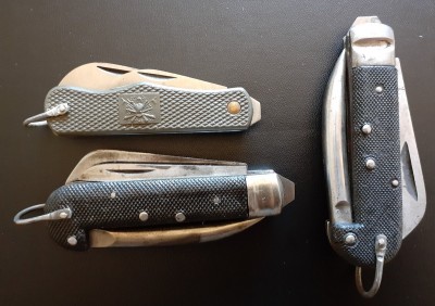Two of these are the same model, by two different manufacturers. Clearly inspired by the WW2-era British Army knives, I've always seen these labeled Italian Navy knives. In the upper left, we have a more recent model (1980s perhaps?) that resembles the Cold War era British Army knife, but smaller and with plastic scales.