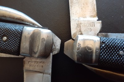 The maker's marks. On the right is the knife that was on the bottom in the previous picture. It's stamped Visconti Canzo. On the left in an example of rougher construction and condition. The stamp is difficult to make out, but I looked up some other examples of these and I'm pretty sure its supposed to be F.lli (Fratelli) Turco Napoli.