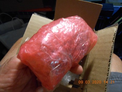 When I open the box there was a tightly wrapped wad of red plastic bubble wrap sealed with clear tape.