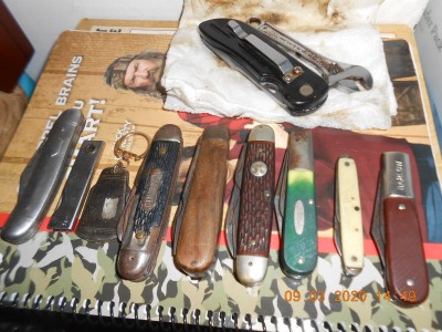 Things got a bit better when I began to inspect the contributions made by Stanwade. From left to right you can see what was in the POS package.<br />1-a hairless Imperial shell handled 3 blade stockman<br />2-a 3 blade utility knife made by H.C. Cook Ansonia, CT<br />3-USA key chain fob with 2 chisel ground blades<br />4-a Camp Buddy (never saw this stamp before)<br />5-a pretty decent Ulster electricians knife, TL-29 Maybe?<br />6-an Ulster Boy Scout knife<br />7-a Camillus made Remington Barlow<br />8-a Colonial advertising knife<br />9-an Irish Barlow made by Imperial<br />The 2 at the top still covered in poo, one's some kind of a knife and the other is a froze up 4" RIDGID adjustable wrench.