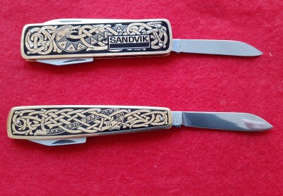 On the opposite side of the knives, both are decorated with a classic knotted Nordic serpent motif. The 3 piece knife (above) is marked with the Sandvik  logo. The bottom knife has an additional tang stamp that reads "Sweden Stainless".
