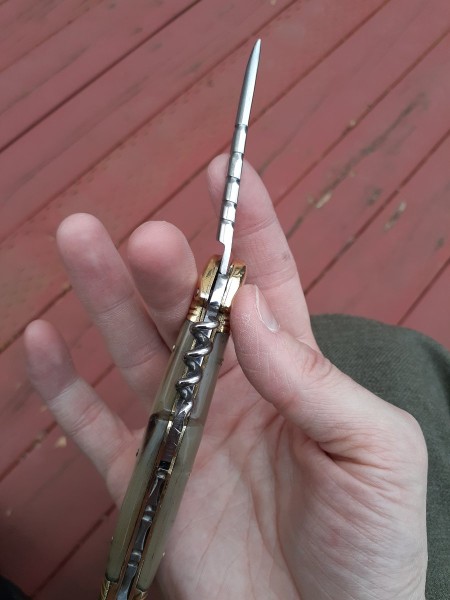 While the blade is centered in the open position, the awl is offset.