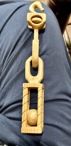 Hook and swivel to chain links to ball in a cage