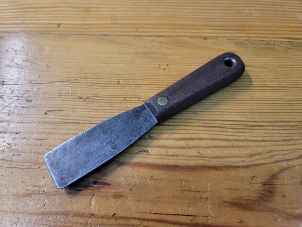 Rosewood handle?  brass rivets.  Probably a ~100 year old putty knife for 50 cents.