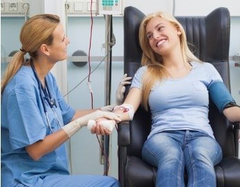 female-patient-getting-blood-drawn-and-looking-at-nurse-picture-id178526818-min.jpg
