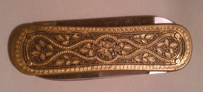 The knife is about 2 inches long or a pinky's length.