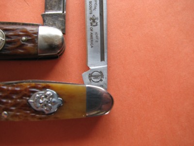 Note the difference in the width of the pull cut.  The repro pull is considerably wider and deeper.   Also the tang on the repro does not square with the blade.