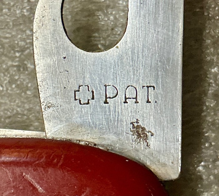 The Can Opener Tool Front Stamp.