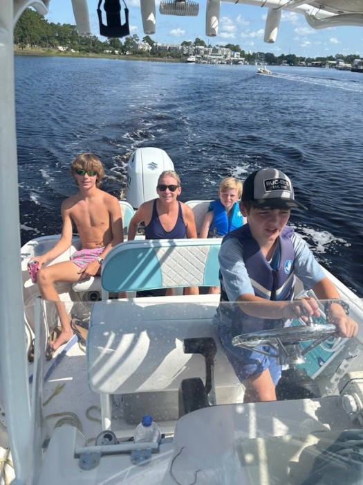 grandson Dawson handling the boat.